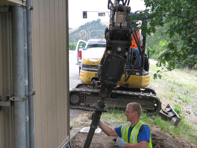 ODOT Foundation Repair - Helical Piers in Myrtle Creek, OR Crew aligning a helical pier beside the ODOT weigh station foundation