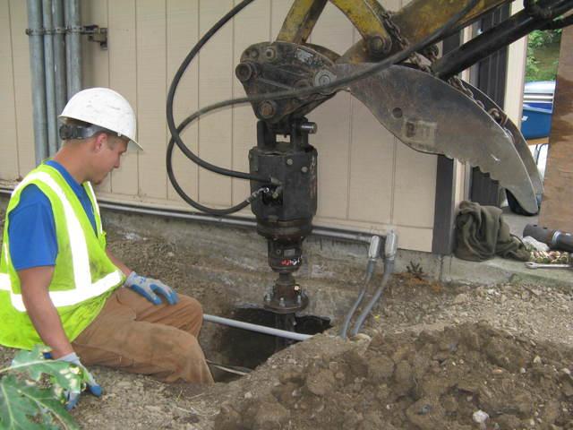 ODOT Foundation Repair - Helical Piers in Myrtle Creek, OR Helical pier installation equipment beside the ODOT weigh station scale shack