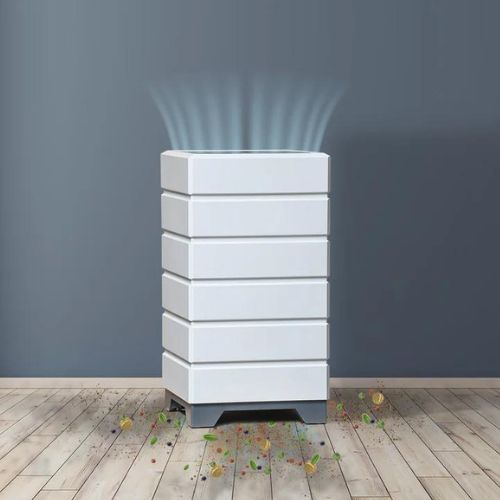 Air purifier on a wooden floor with particles being drawn in.