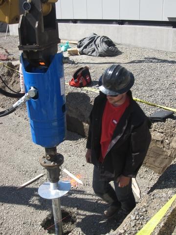 106 Pier Installation in Union Gap, WA Hydraulic equipment driving a helical pile during the Union Gap commercial project
