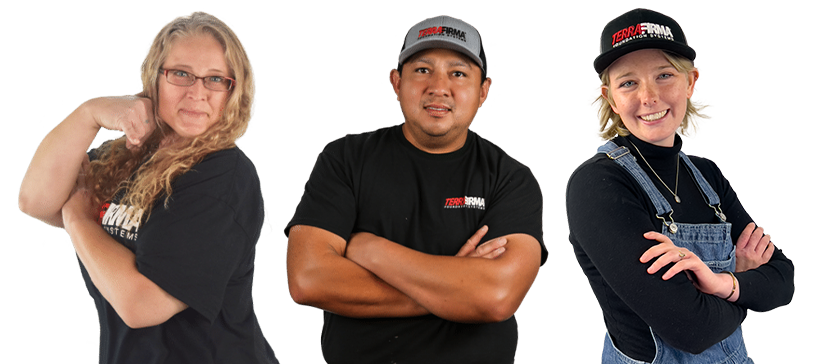 Three Terrafirma employees posing with crossed arms, wearing branded apparel.